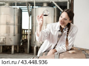Female employee in white robe posing at winery. Стоковое фото, фотограф Татьяна Яцевич / Фотобанк Лори