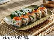 Japanese food. Sushi rolls California, Philadelphia with eel, red caviar and salmon. The concept of the sushi bar menu. Стоковое AI-изображение, AI-художник Photojuli / Фотобанк Лори