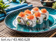 Japanese food. Sushi rolls California, Philadelphia with eel, red caviar and salmon. The concept of the sushi bar menu. Стоковое AI-изображение, AI-художник Photojuli / Фотобанк Лори