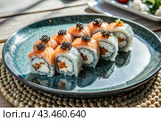 Japanese food. Sushi rolls California, Philadelphia with eel, red caviar and salmon. The concept of the sushi bar menu. Стоковое AI-изображение, AI-художник Photojuli / Фотобанк Лори