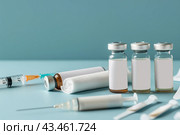 Syringe and glass vial on blue background table. Medical Vials group, needles, ampoules, bottle with medicines or vaccine. Disease treatment. Creative Banner. Anti-aging beauty injections. Vaccination. Стоковое AI-изображение, AI-художник Марина Демидюк / Фотобанк Лори