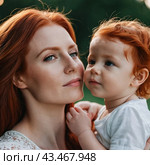 A mother lovingly gazes at her infant baby, holding the child close in her arms. Cute infant child is calm. Love of mother and child. Happy childhood. Family relationships, motherhood and fertility. Стоковое AI-изображение, AI-художник Юлия Петровская / Фотобанк Лори
