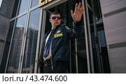 An employee of the security company asks with a gesture to stop. The concept of policing. Стоковое AI-изображение, AI-художник Ярославский Максим / Фотобанк Лори