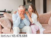 Grown up daughter soothe aged father holds his hand feel empathy give him moral support, sad elderly man at home. Стоковое фото, фотограф Гладских Татьяна / Фотобанк Лори