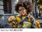 A pretty black African American woman in glasses with a bouquet of autumn flowers goes to school for the first time. A child with a school bag, a book and flowers. A child on a city street. Back to school. Стоковое AI-изображение, AI-художник Photojuli / Фотобанк Лори