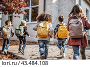 The holiday falls on September 1st. Children with yellow backpacks run to school. Rear view. Back to school. The concept of a new academic year at school. Autumn Knowledge Day. Стоковое AI-изображение, AI-художник Photojuli / Фотобанк Лори