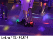 Photography of beautiful dancing people on the night party in the city street in summer night. Leisure, happiness and entertainment theme. Стоковое фото, фотограф YuryKara / Фотобанк Лори