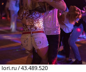 Photography of beautiful dancing people on the night party in the city street in summer night. Leisure, happiness and entertainment theme. Стоковое фото, фотограф YuryKara / Фотобанк Лори