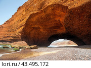 Spectacular natural red arch on atlantic ocean coast, Legzira (or Gzira) beach. Red archs on atlantic ocean coast. Sidi Ifni, Morocco, Africa (2024 год). Стоковое фото, фотограф Евгений Ткачёв / Фотобанк Лори