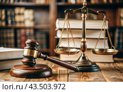 Justice and the law. A wooden hammer, books and scales on the table. The court session. Стоковое AI-изображение, AI-художник Photojuli / Фотобанк Лори