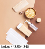 Cosmetology wax and body care tools in aesthetic composition on beige. Стоковое фото, фотограф Юлия Трикашная / Фотобанк Лори