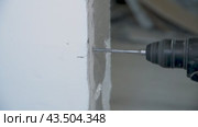 Drilling a concrete wall with a drill to attach a door frame. Repair work. Drilling a hole. Accelerated shooting. Стоковое видео, видеограф Дмитрий Кобзев / Фотобанк Лори