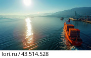 Cargo Ship Docked at Port With Container Yard and Car Driving in Foreground. Стоковое AI-изображение, AI-художник Юлия Гапеенко / Фотобанк Лори
