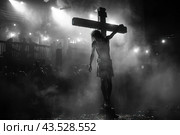 A scene done in black and white, with a figure crucified on a cross in the center of the composition. There are many people around the cross watching what is happening. The background is shrouded in thick fog or smoke, creating an atmosphere of mysticism and drama. The light rays illuminate the figure on the cross and part of the surrounding crowd, enhancing the contrast between light and shadow. Стоковое AI-изображение, AI-художник Анна Кривицкая / Фотобанк Лори