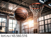 A basketball is flying into the ring on the basketball court. A goal. The ball is in close-up. Стоковое AI-изображение, AI-художник Photojuli / Фотобанк Лори