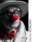 Close-up selective color portrait of sad clown. An elderly man in a white coat and hat. Стоковое фото, фотограф Сергей Пристяжнюк (Serg Zastavkin) / Фотобанк Лори