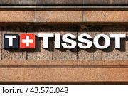 Вывеска TISSOT на фасаде дома. Название и логотип известной швейцарской часовой компании (2024 год). Редакционное фото, фотограф Константин Григорьев / Фотобанк Лори