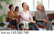Group of interested positive women of different ages sitting in auditorium and listening attentively to master class. Стоковое видео, видеограф Яков Филимонов / Фотобанк Лори