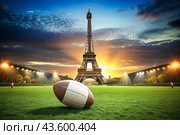 American football. A rugby ball on the background of the Eiffel Tower. The concept of sports games and competitions. The Summer Olympic Games. Стоковое AI-изображение, AI-художник Photojuli / Фотобанк Лори