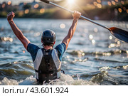 A kayaker celebrates his victory with an oar in his hands on a blurred background of the river. Kayaker at the Summer Olympics. Стоковое AI-изображение, AI-художник Photojuli / Фотобанк Лори