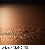 A close-up of bronze surface with a gradient, featuring curved lines and subtle light reflections. The texture of the bronze is smooth and metallic, creating a visually captivating abstract image. AI. Стоковое AI-изображение, AI-художник Юлия Петровская / Фотобанк Лори