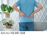Back pain, kidney stones, inflammation and disease, man suffering from backache at home. Стоковое фото, фотограф Станислав Тарко / Фотобанк Лори