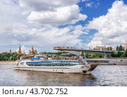 Прогулочный кораблик Рэдиссон, парк Зарядье, парящий мост и Кремль, Москва-река, Москва (2024 год). Редакционное фото, фотограф Baturina Yuliya / Фотобанк Лори