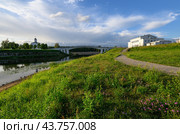 Summer city Tver landscape concept of Church of St. Michael, Grand Prince of Tver on river Volga surface, green grass embankment, bridge and cloudy sky, trees and builduing. Tver, Tourism in Russia. Стоковое фото, фотограф Евгений / Фотобанк Лори