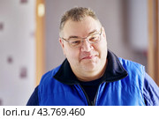 Plump cheeky man in her 40s suppresses smile. Стоковое фото, фотограф Владимир Григорьев / Фотобанк Лори