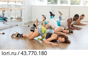 Graceful brunette mastering floorwork during high heels dance routine. Стоковое фото, фотограф Яков Филимонов / Фотобанк Лори
