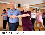 Elderly woman and man practicing jitterbug moves in dance studio. Стоковое фото, фотограф Яков Филимонов / Фотобанк Лори