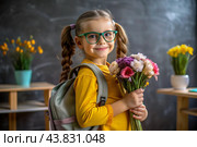 A sweet, beautiful first-grader girl with glasses. In the hands of a bouquet of flowers. The child goes to school for the first time. A child with a backpack, a book and flowers. Back to school. Стоковое AI-изображение, AI-художник Photojuli / Фотобанк Лори