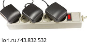 Блок питания в розетке на белом фоне. AC/DC adapter  on white background. Стоковое фото, фотограф Татьяна Д / Фотобанк Лори