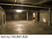 Abandoned basement interior with dim lighting. Стоковое AI-изображение, AI-художник Иван Рябоконь / Фотобанк Лори
