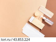 Creative composition with hair removal tools arranged on beige-brown background with copy space. Стоковое фото, фотограф Юлия Трикашная / Фотобанк Лори