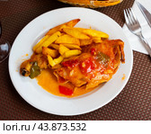 French fries and piece of fried chicken is served on large white platter, completed with beer. Стоковое фото, фотограф Яков Филимонов / Фотобанк Лори