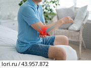 Diseases of the elbow joint, bone fracture, inflammation and dislocation, man suffering from pain in cubit, dislocated arm. Стоковое фото, фотограф Станислав Тарко / Фотобанк Лори