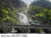 Holiday trip in motorhome, Caravan car Vacation. RV traveling on the road Latefossen Waterfall Odda Norway. Latefoss is a powerful, twin waterfall. Стоковое фото, фотограф Андрей Армягов / Фотобанк Лори