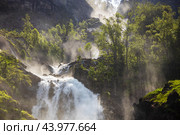 Latefossen is one of the most visited waterfalls in Norway and is located near Skare and Odda in the region Hordaland, Norway. Consists of two separate streams flowing down from the lake Lotevatnet. (2019 год). Стоковое фото, фотограф Андрей Армягов / Фотобанк Лори