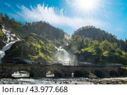 Latefossen is one of the most visited waterfalls in Norway and is located near Skare and Odda in the region Hordaland, Norway. Consists of two separate streams flowing down from the lake Lotevatnet. (2019 год). Стоковое фото, фотограф Андрей Армягов / Фотобанк Лори