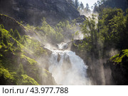 Latefossen is one of the most visited waterfalls in Norway and is located near Skare and Odda in the region Hordaland, Norway. Consists of two separate streams flowing down from the lake Lotevatnet. (2019 год). Стоковое фото, фотограф Андрей Армягов / Фотобанк Лори