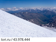 Mountain landscape, view from highland icefield on slope to mountain ranges in the clouds, view from the Mount Elbrus to the Main Caucasian Range. Стоковое фото, фотограф Евгений Харитонов / Фотобанк Лори