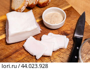 Simple hearty snack is served on board - salted lard salo, bran bread and horseradish seasoning. Стоковое фото, фотограф Яков Филимонов / Фотобанк Лори