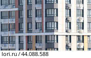 Moscow, March 02 2024, A new building in close-up, the concept of a preferential mortgage. A large building with many windows and a clear blue sky in the background. Редакционная иллюстрация, иллюстратор Скрипачев Антон / Фотобанк Лори