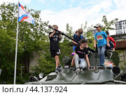 Дети увлечено  играют на бронетранспортере БТР-82. Город Тюмень (2024 год). Редакционное фото, фотограф Александр Тараканов / Фотобанк Лори