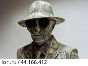 Mysterious figure cloaked in money. Стоковое AI-изображение, AI-художник Иван Рябоконь / Фотобанк Лори