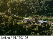 View of an ancient village and fortress towers in mountains of Svaneti. Landscape of Georgia. Стоковое фото, фотограф KOSIM / Фотобанк Лори