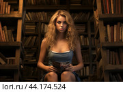 Elegant woman reading in vintage library. Стоковое AI-изображение, AI-художник Иван Рябоконь / Фотобанк Лори
