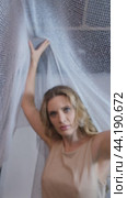 Vertical slow motion video of woman covered with white mesh fabric. A woman hides her face behind a veil cloth. Стоковое видео, видеограф Сергей Пристяжнюк (Serg Zastavkin) / Фотобанк Лори
