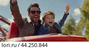 A joyful father and son enjoy a thrilling roller coaster ride at an amusement park on a sunny day, both laughing and raising their hands in excitement. Стоковое AI-изображение, AI-художник Сергей Толмачёв / Фотобанк Лори